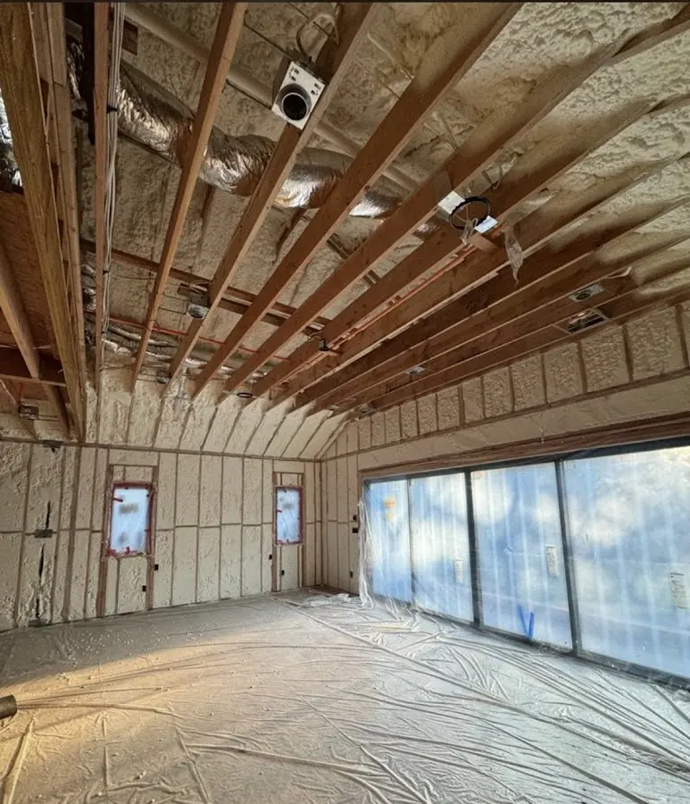 Interior walls and ceiling insulated with spray foam during new construction in Henniker
